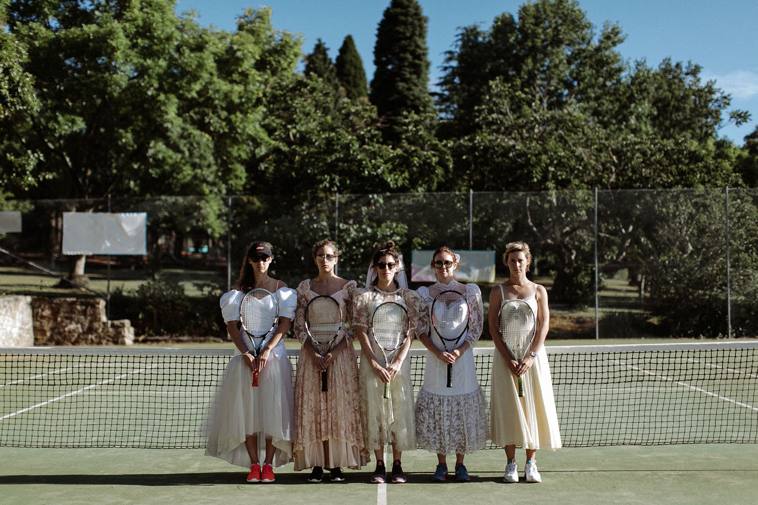 bridesmaids vintage wedding dresses playing tennis