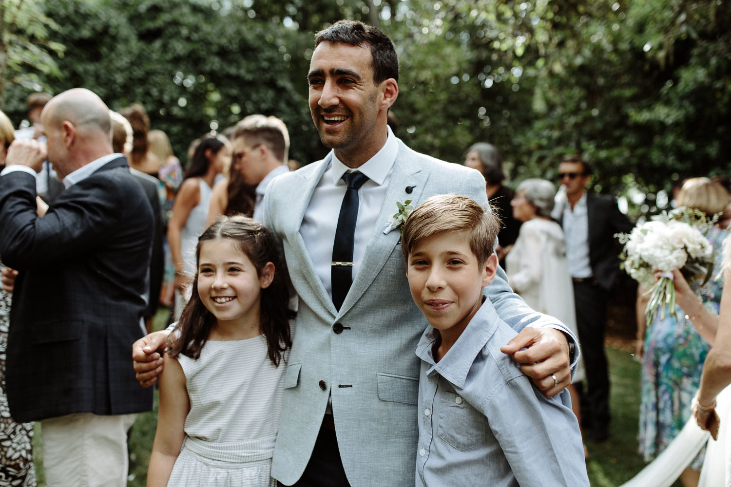 groom laughing with kids