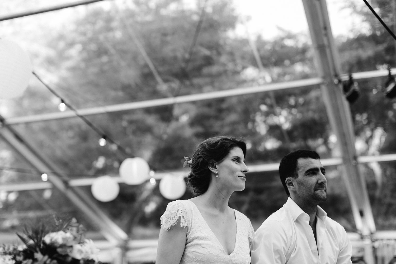 bride and groom watch wedding speeches