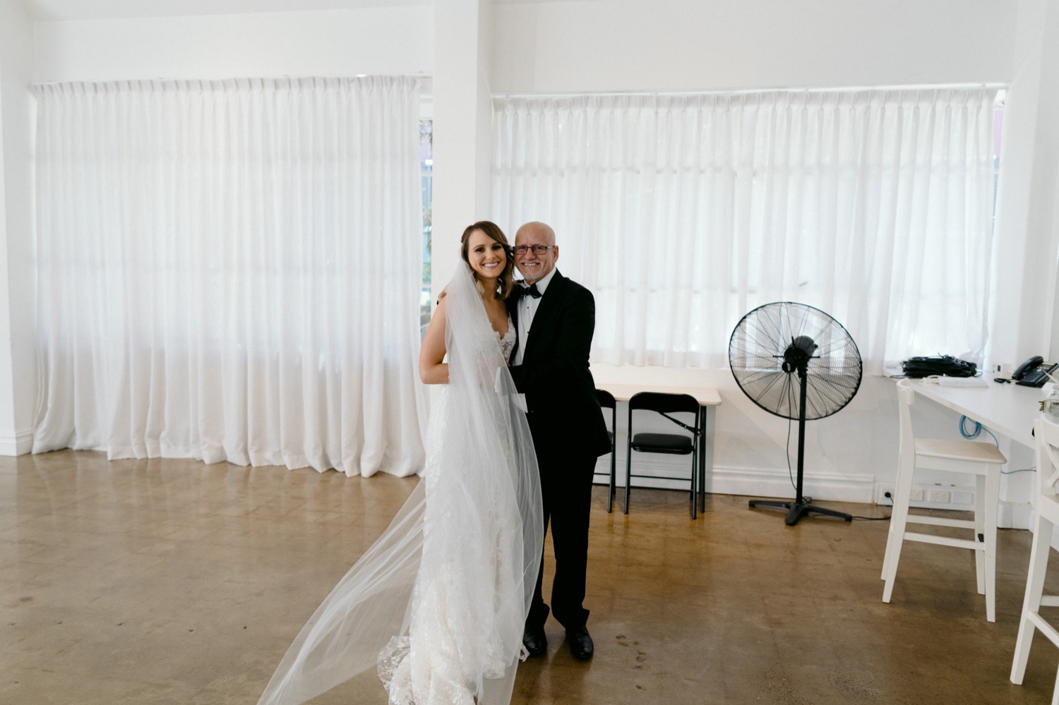 bride and father hugging before wedding ceremony at la porte space
