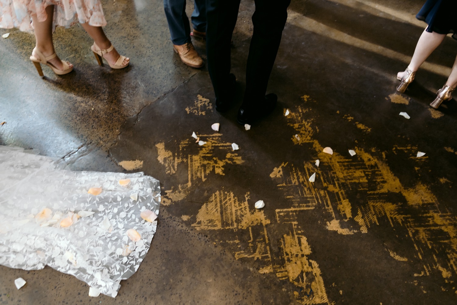 photo of floor showing confetti petals and brides dress