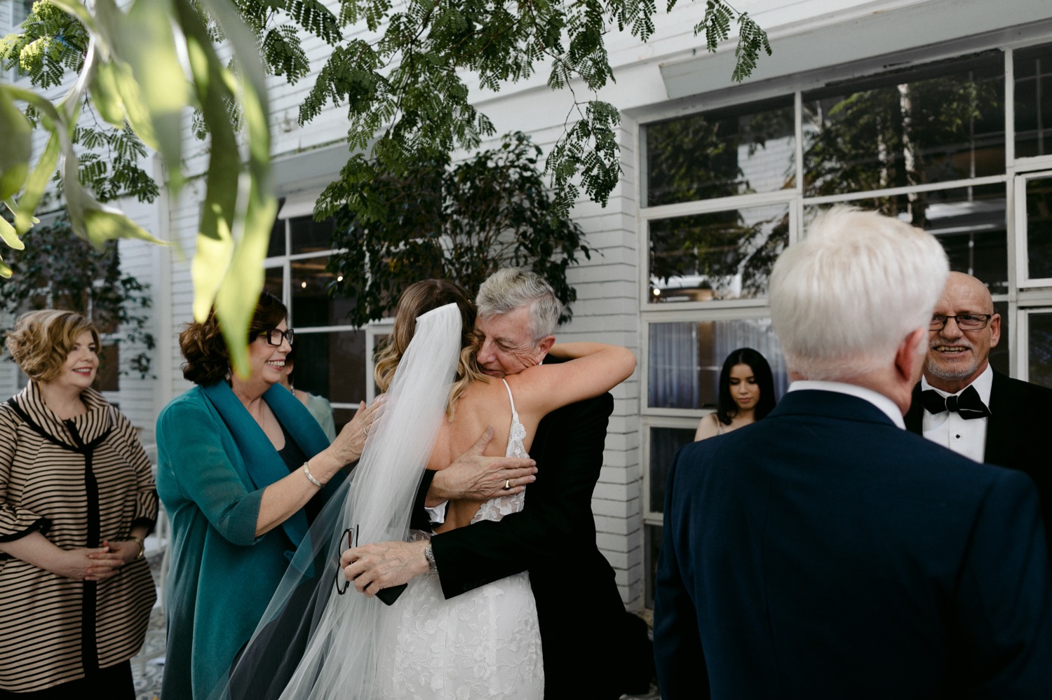 bride hugging grooms father at the end of wedding ceremony