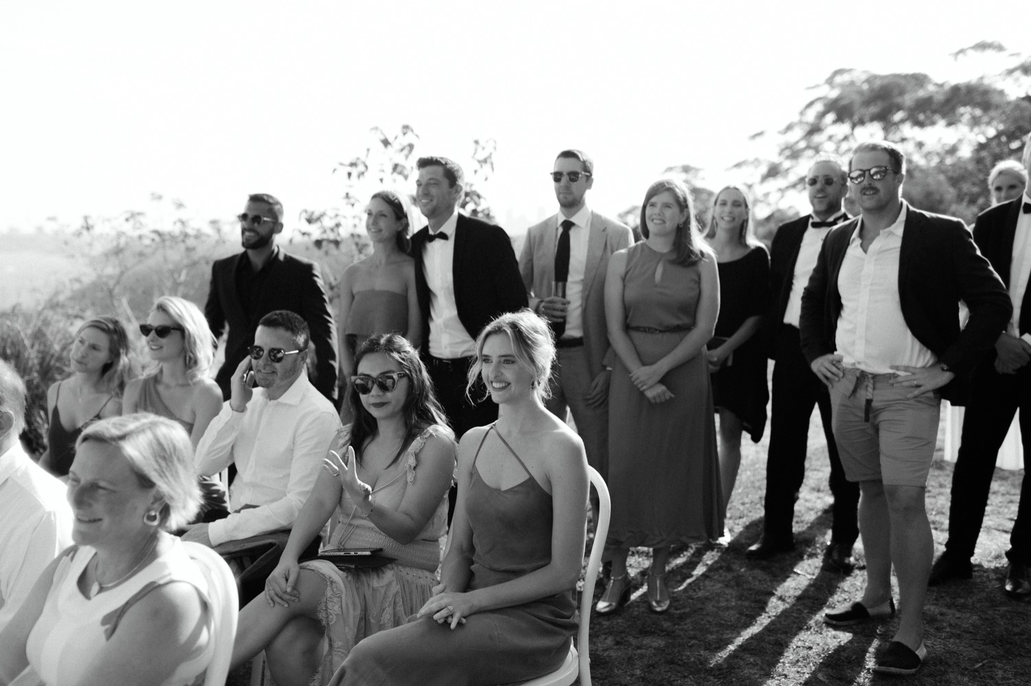 black and white shot of wedding guests at ceremony