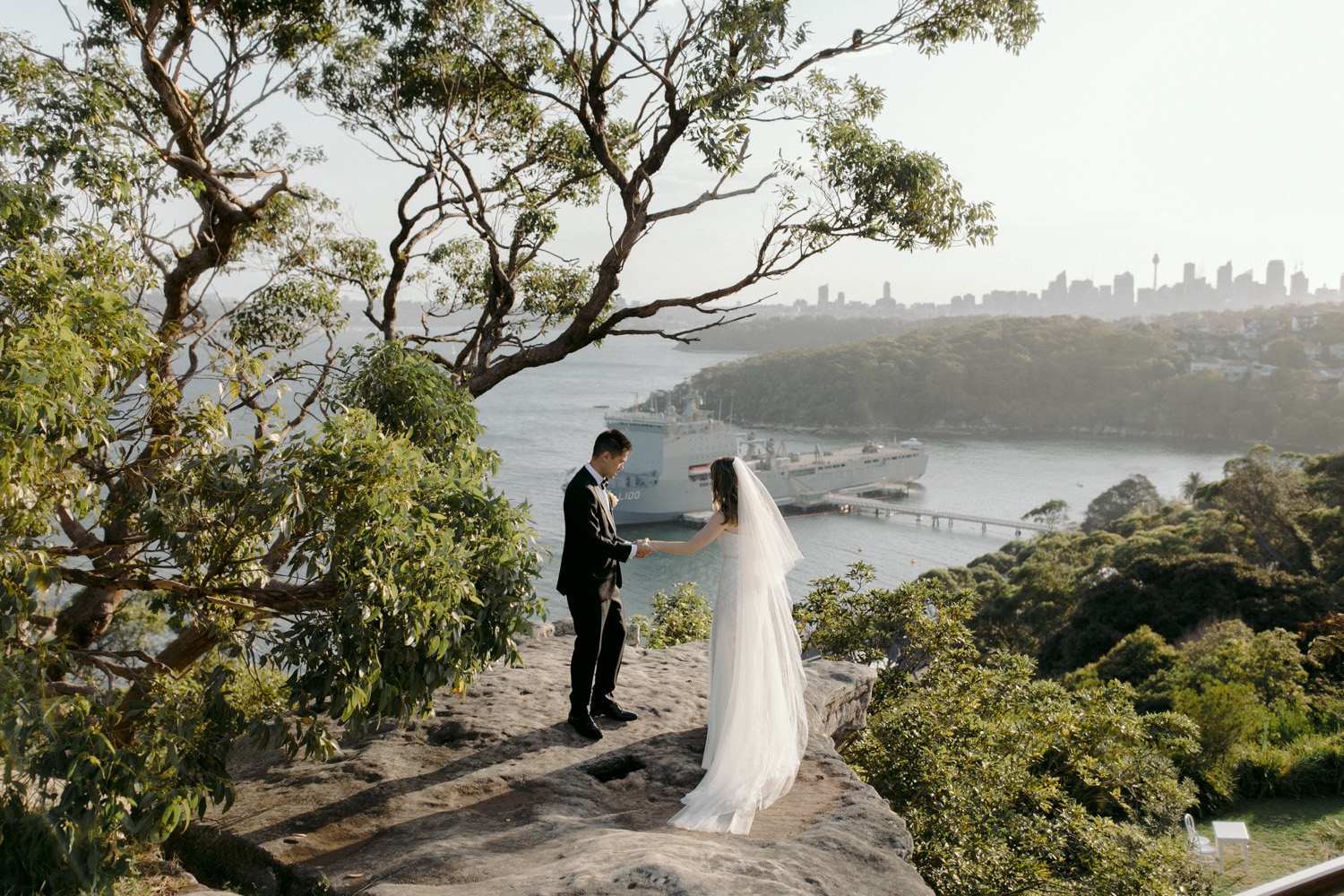 bride and groom looking out over georges head
