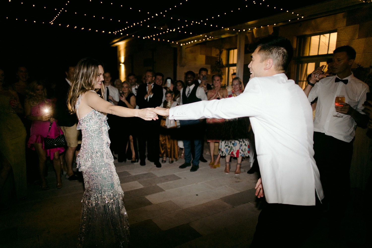 groom spinning bride around during first dance