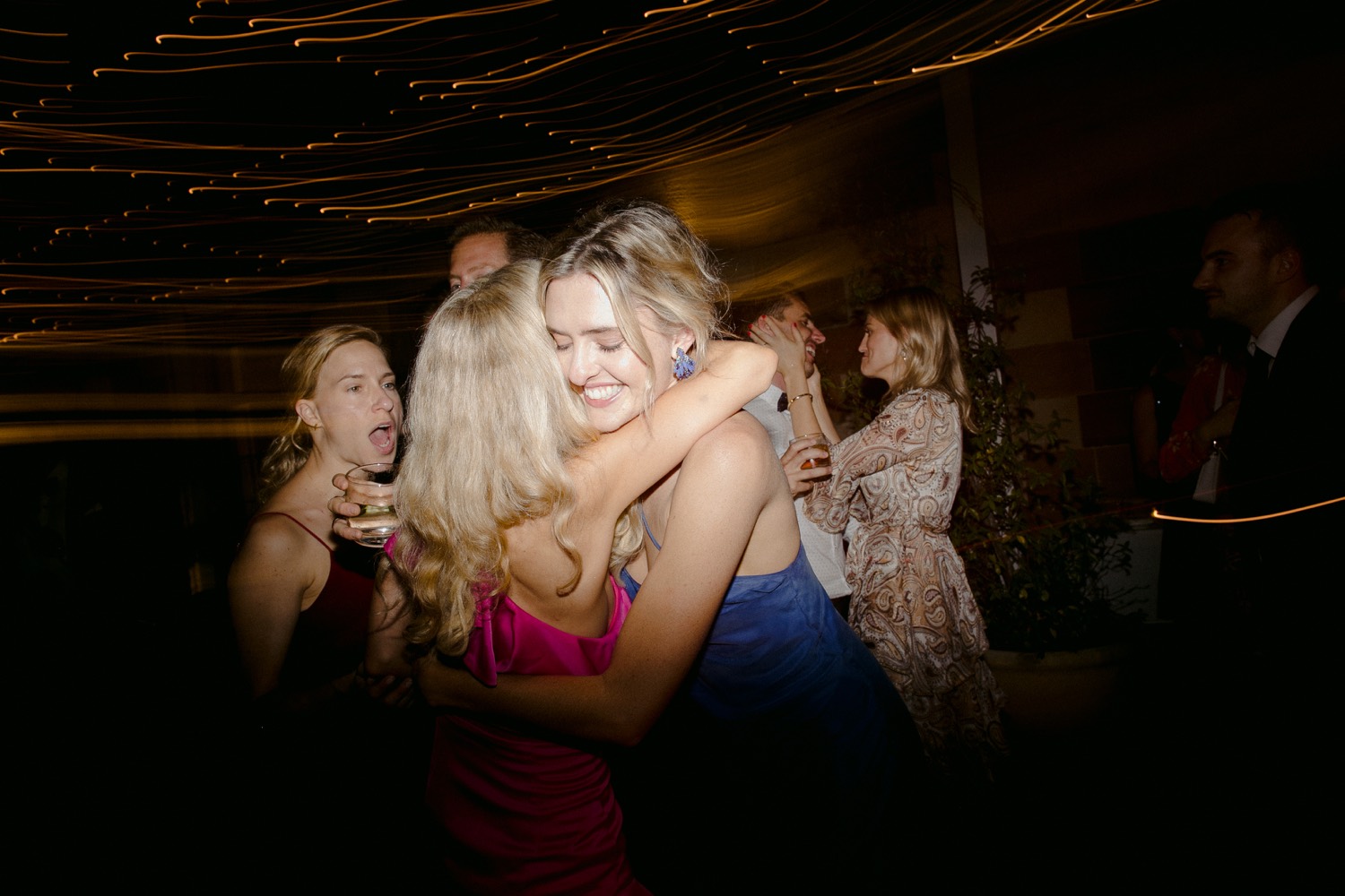 wedding guests hugging on the dance floor