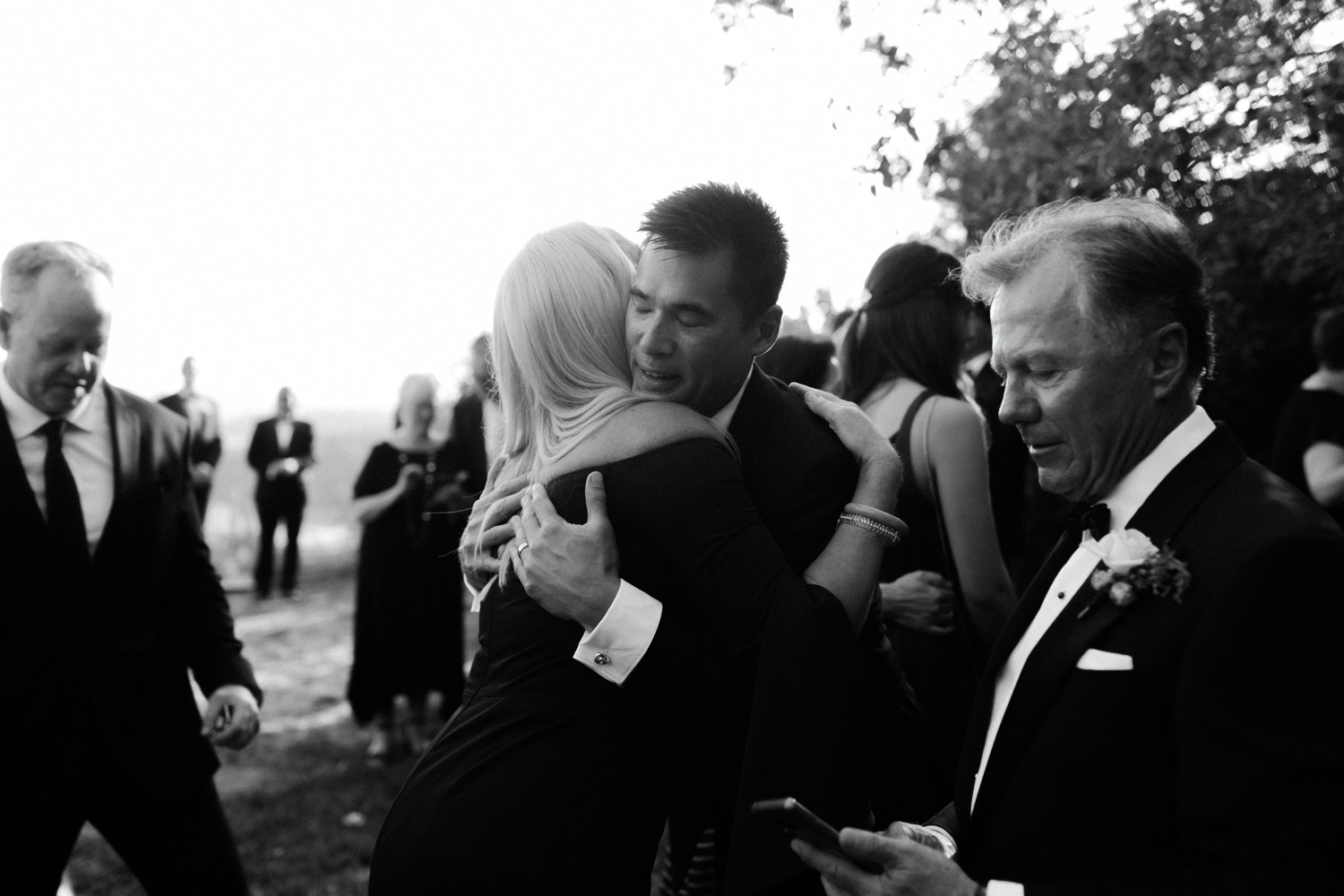 groom hugging guests after wedding ceremony